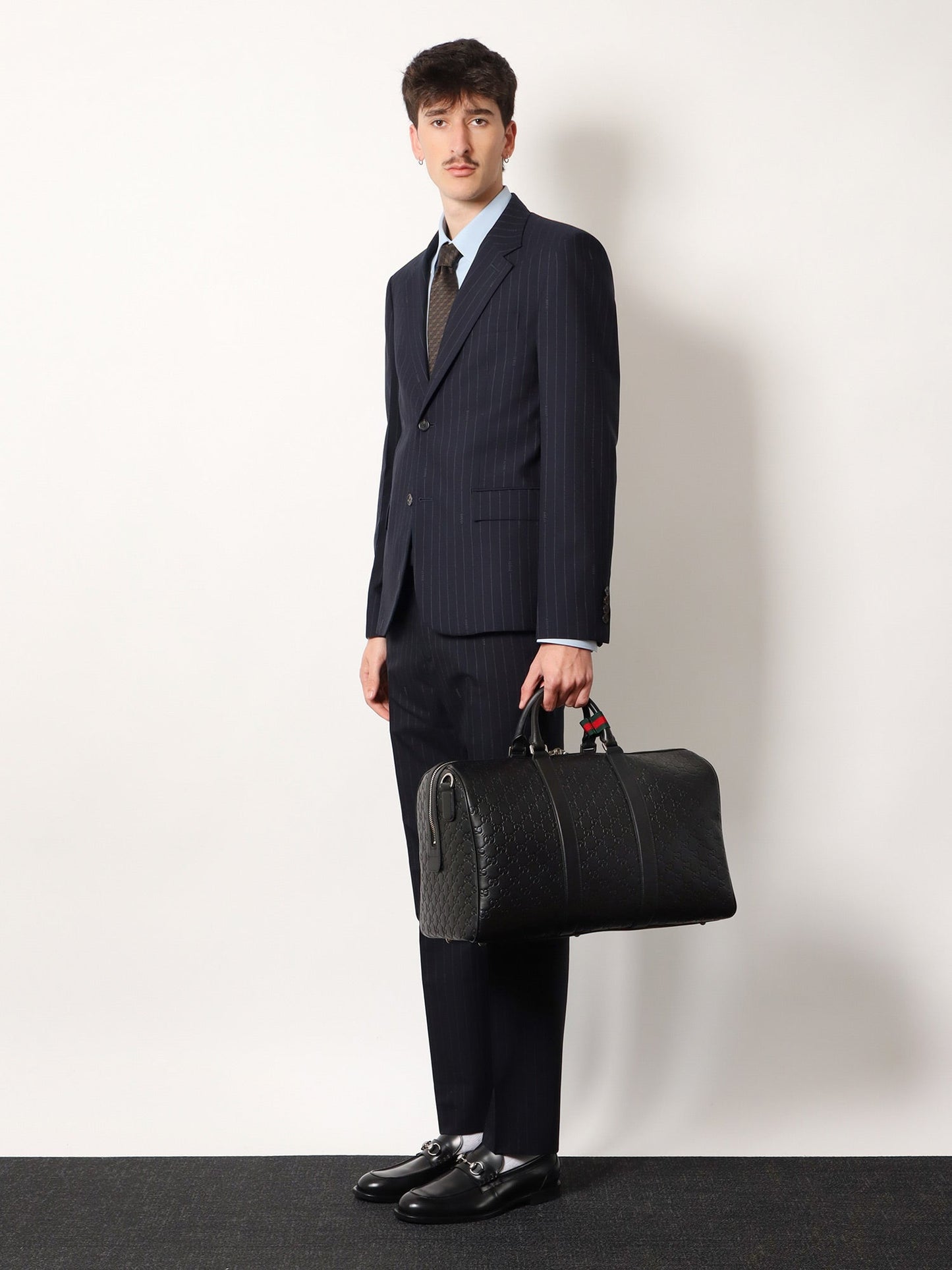 Gucci Men Coated Canvas Gg Emblem Travel Bag With Gg Motif
